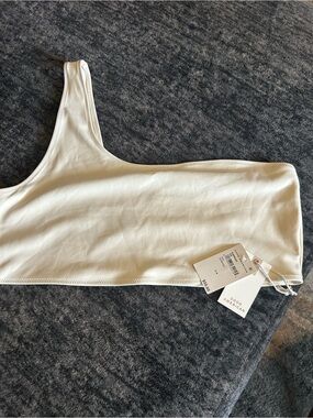 Good American Ivory One-Shoulder bathing suit top.